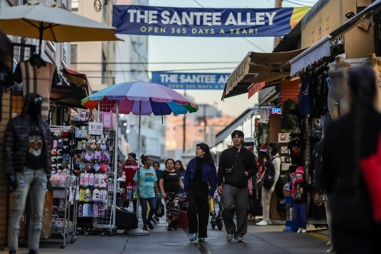 THE SANTEE ALLEY banner above a narrow alley packed with stalls and shoppers