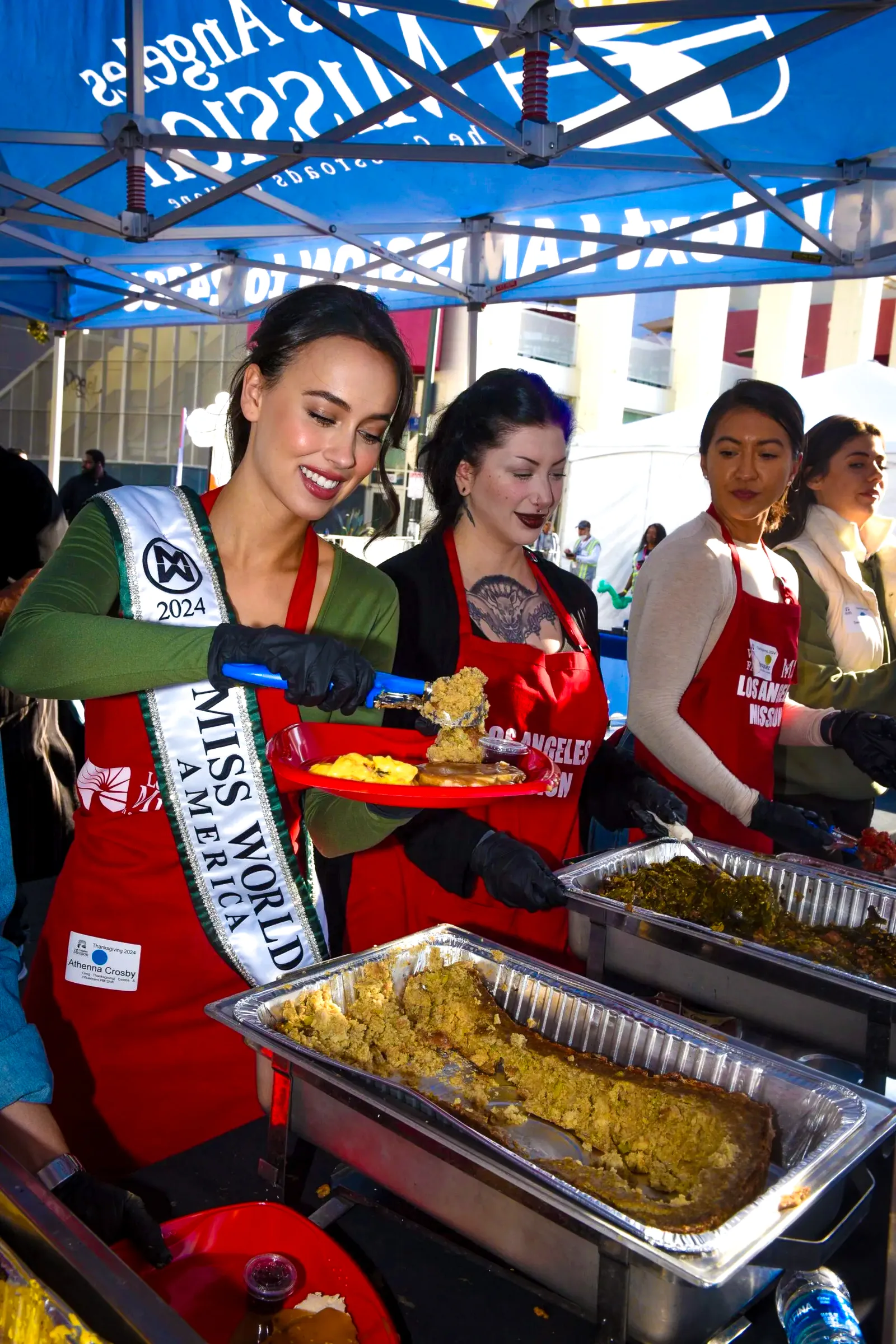 Athenna Crosby wearing Miss World America sash while volunteering and serving the community.