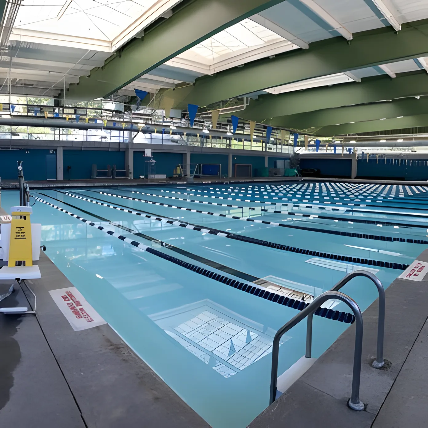 Lane ropes across a bright indoor lap pool