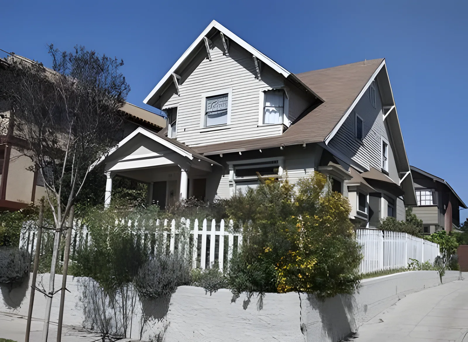 The grey craftsman bungalow with a white picket fence used as the Toretto house