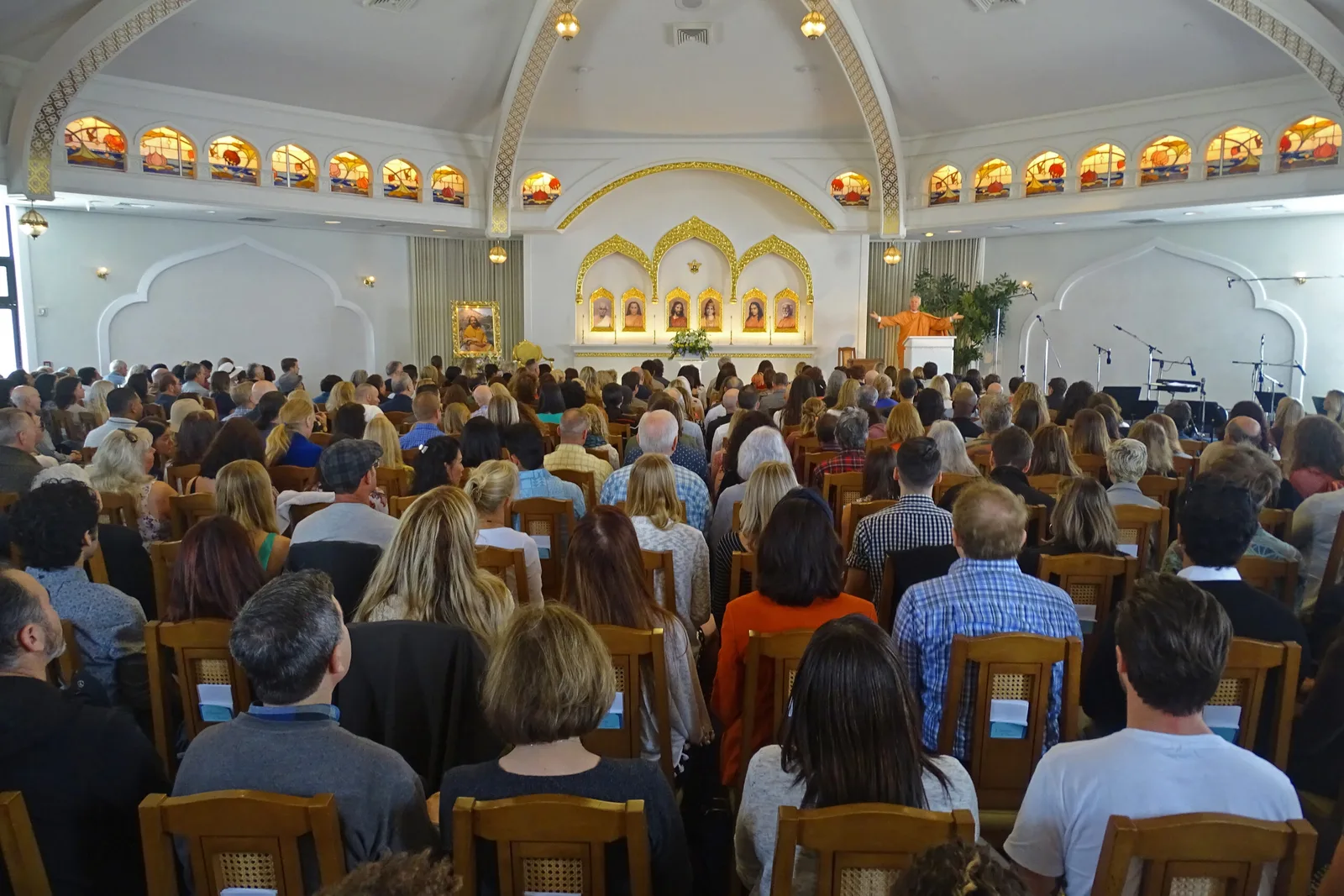 A congregation seated inside the domed sanctuary at the Lake Shrine