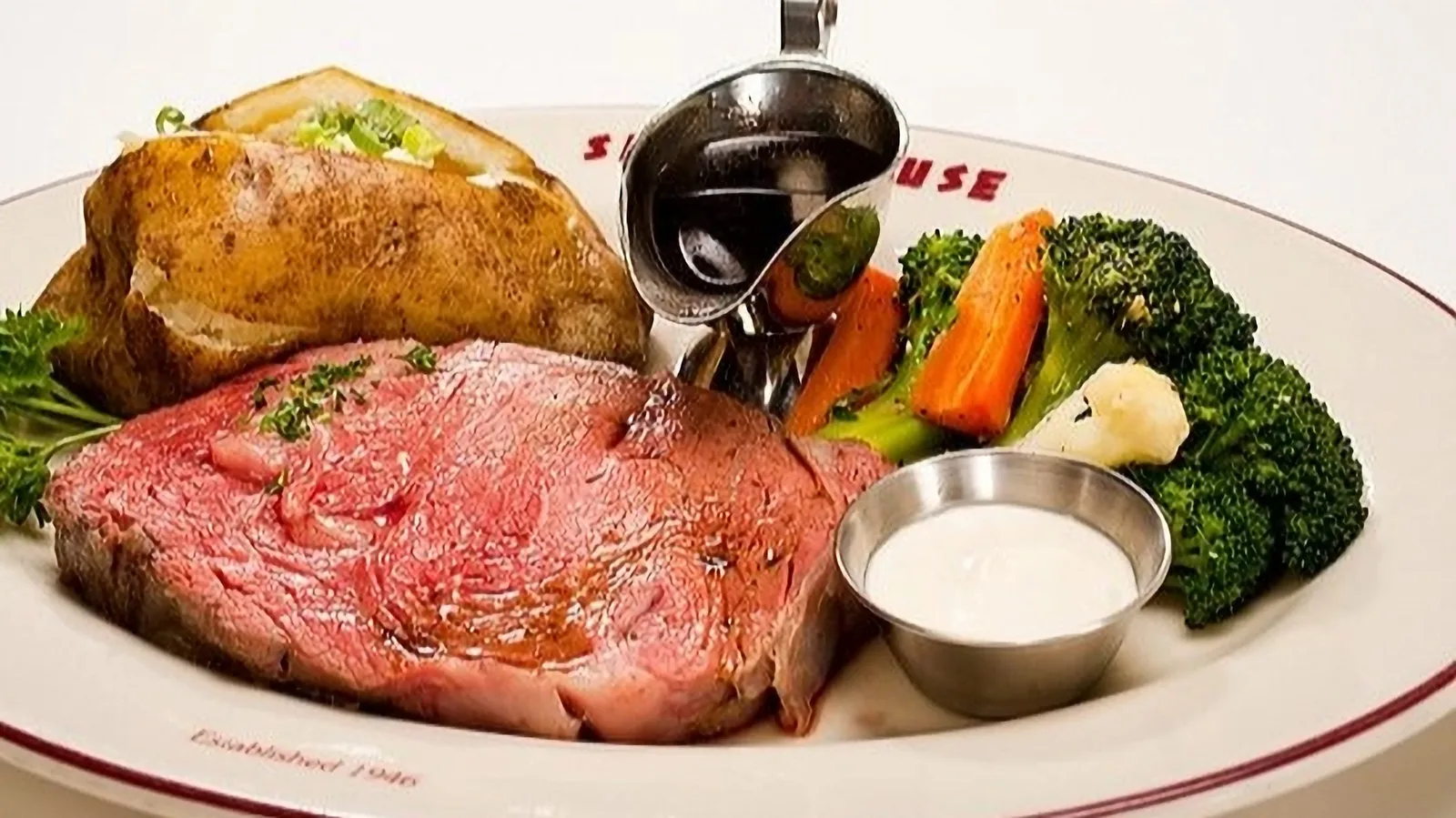 Prime rib with vegetables and a baked potato at the Smoke House