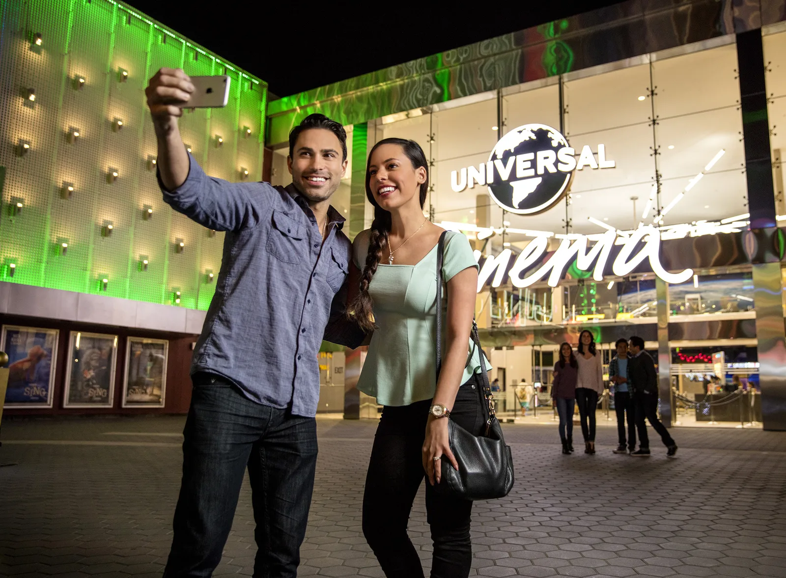 Guests outside the Universal Cinema AMC marquee at CityWalk Hollywood at night