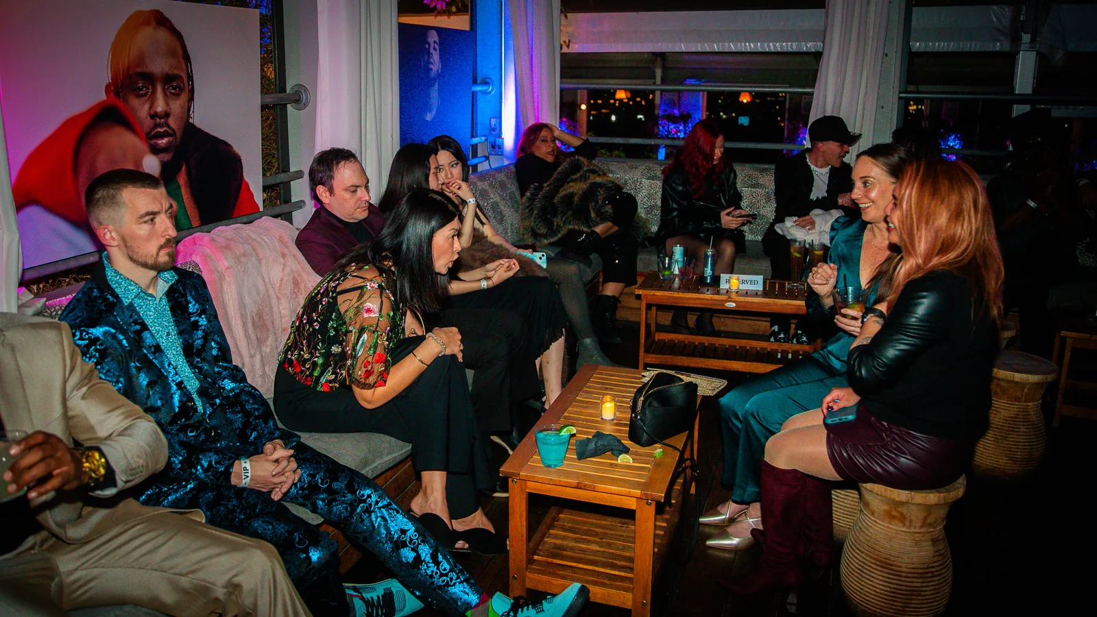 Guests sit on lounge sofas talking at an indoor party space