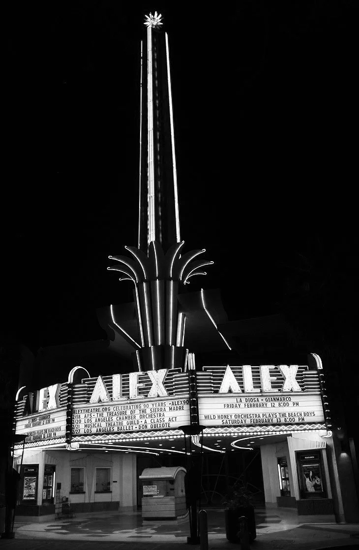 The historic Alex Theatre's neon tower marquee lights up Brand Boulevard in Glendale.