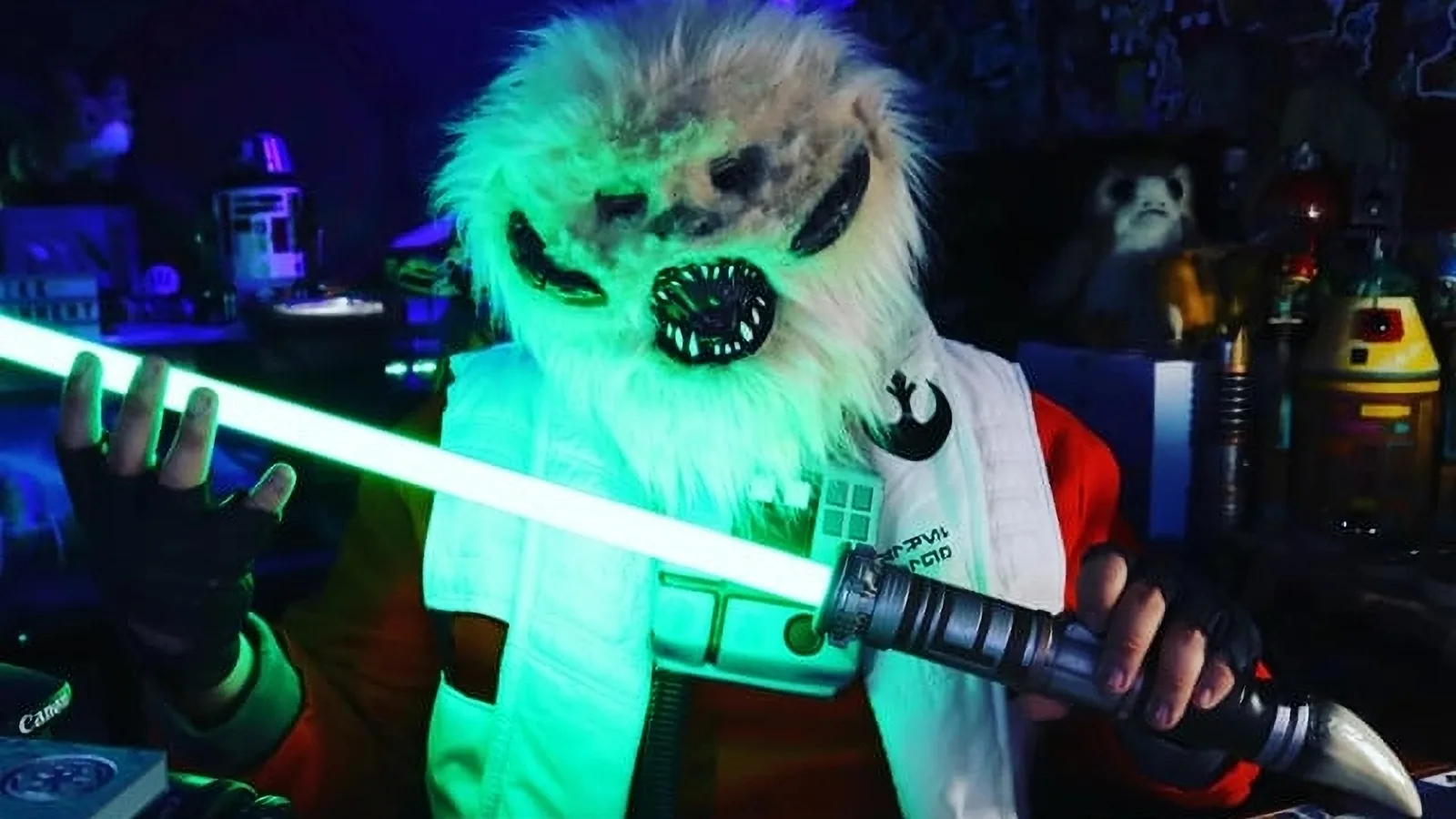 Star Wars-inspired costume, wearing a furry alien mask with sharp teeth, glowing accents and holding a bright green lightsaber at Sender One LAX (11220 Hindry Ave. Los Angeles, CA 90045) 