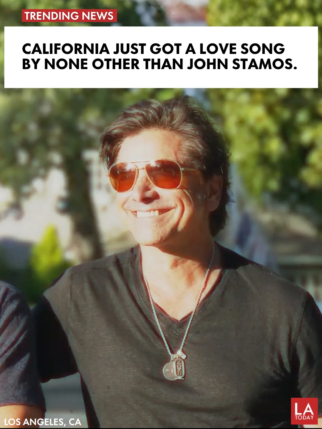 John Stamos and Richard Marx side by side outdoors in sunglasses, from the Take Care of California music video shoot