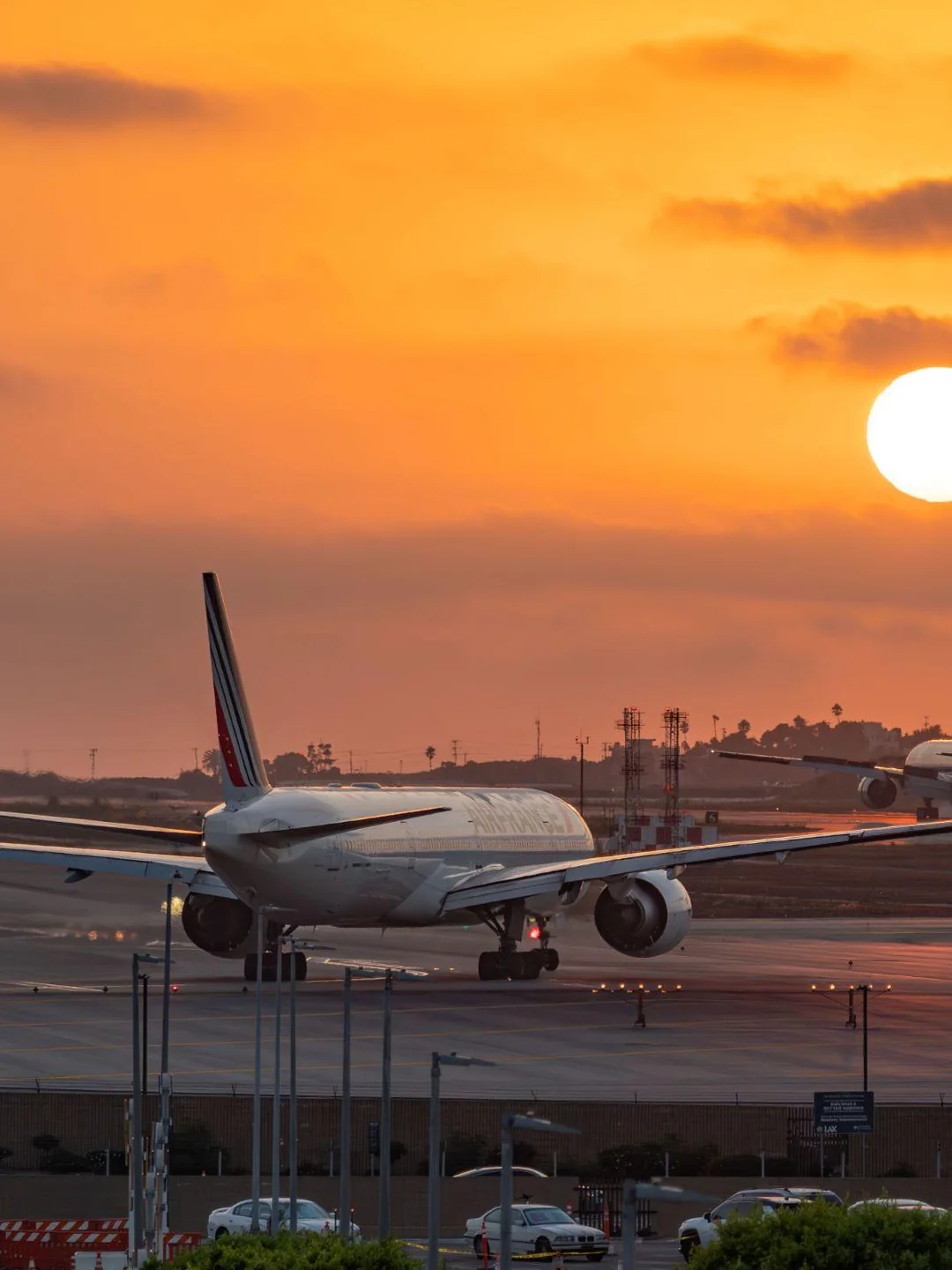 Airliners parked at Los Angeles International Airport gates at sunset
