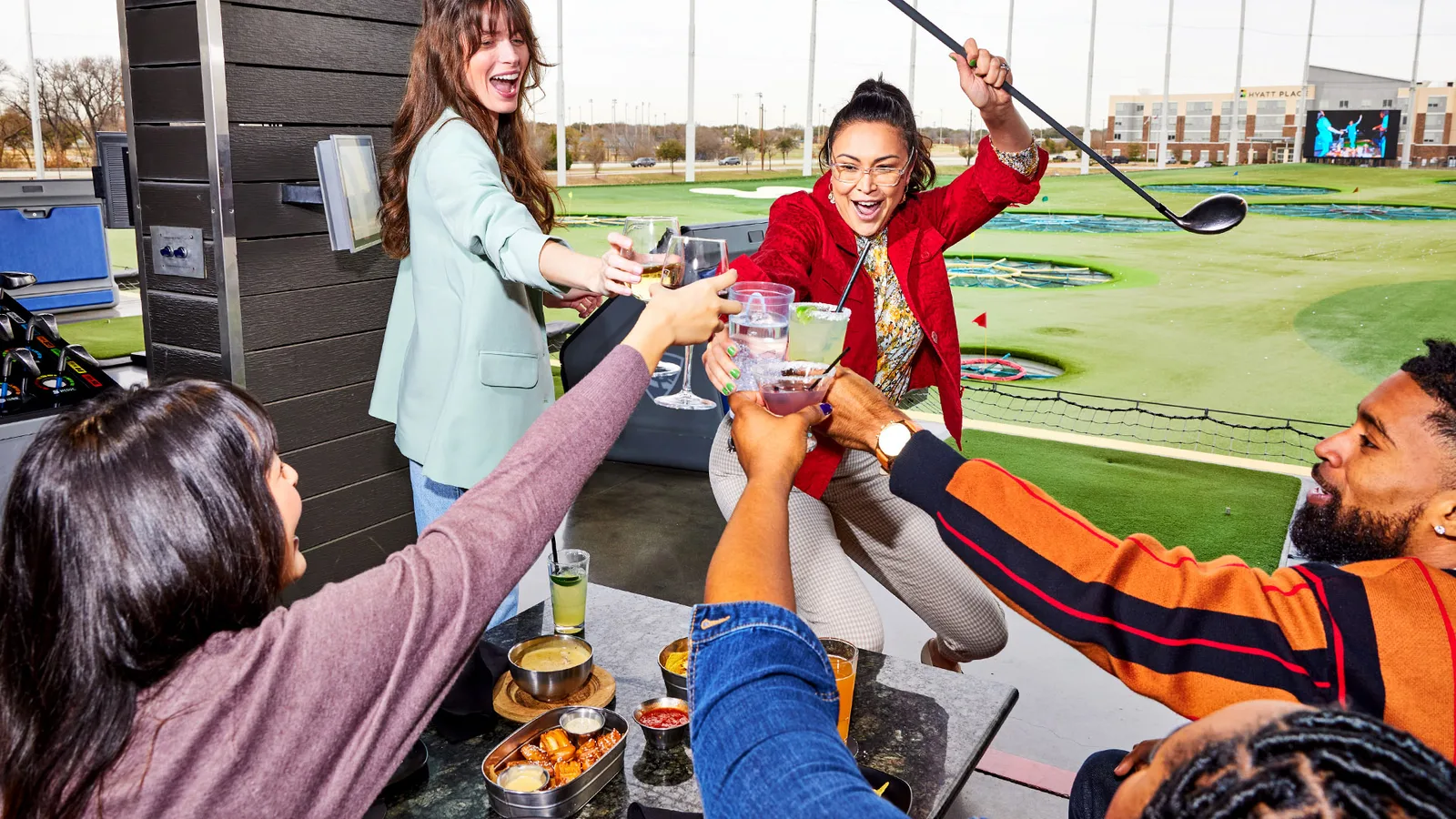 Group enjoying the hitting bays at Topgolf El Segundo