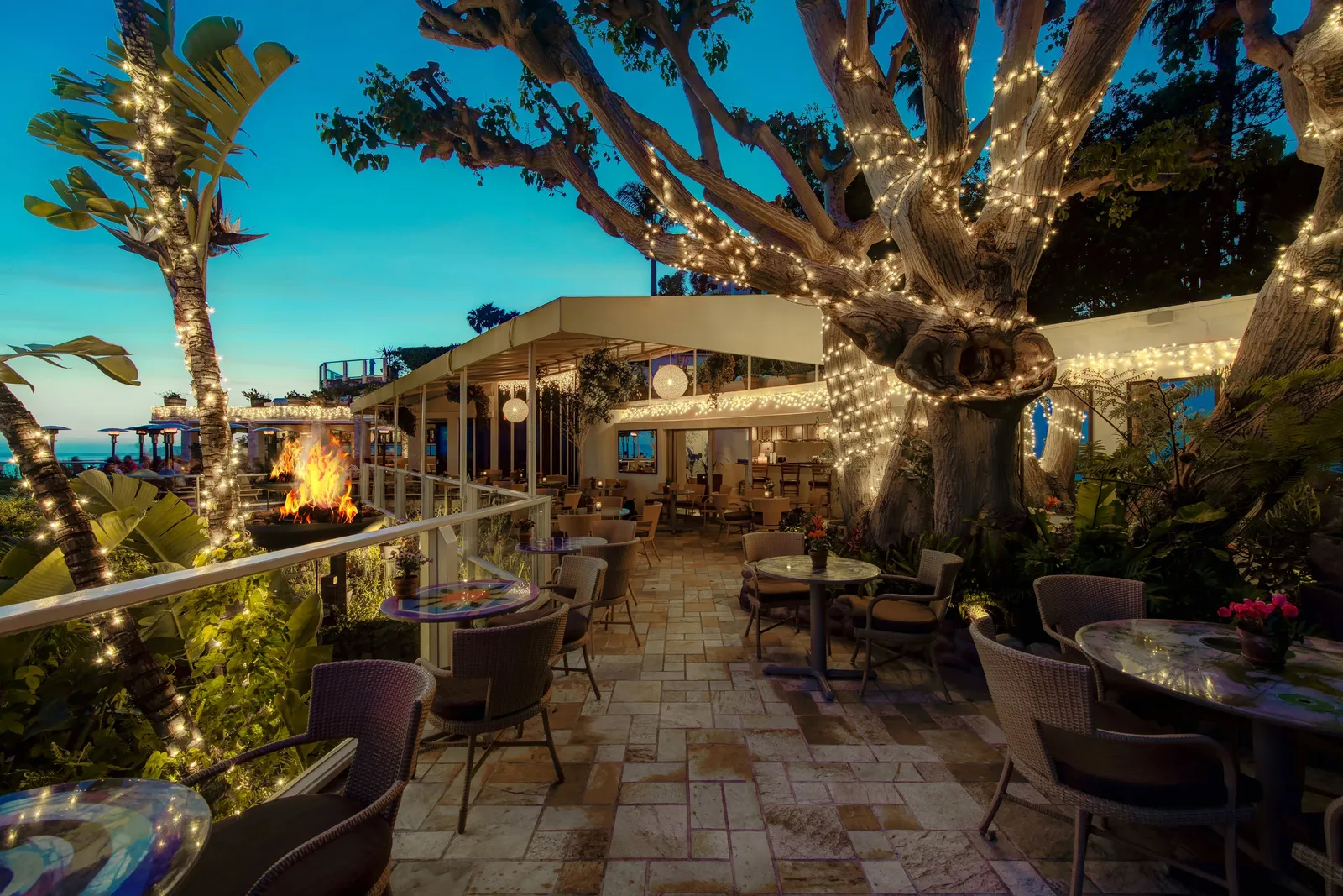 Oceanfront patio dining at sunset at Geoffrey's Malibu
